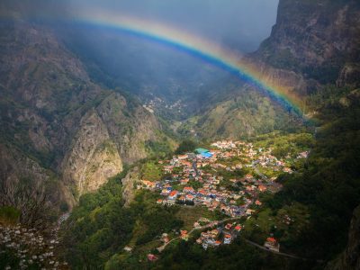 amazing view of a small cozy village Curral das Freiras with a rainbow above, Madeira, Portugal